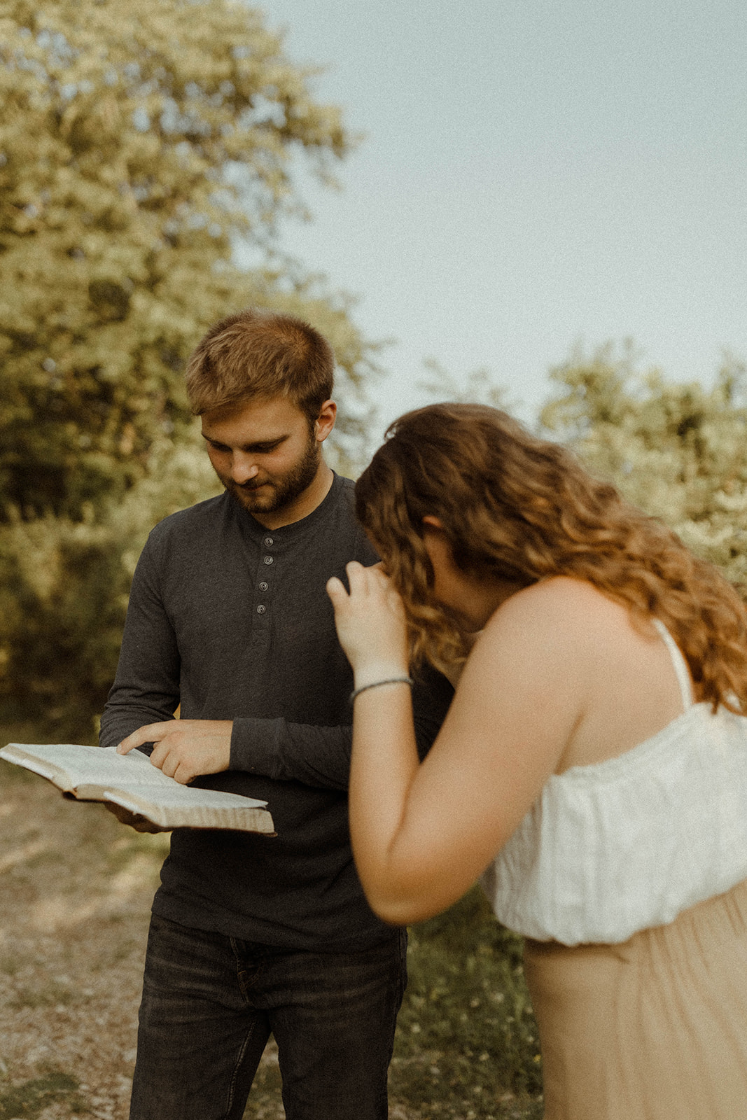 Sweet couple reading the bible together during their Upstate New York couples photoshoot.