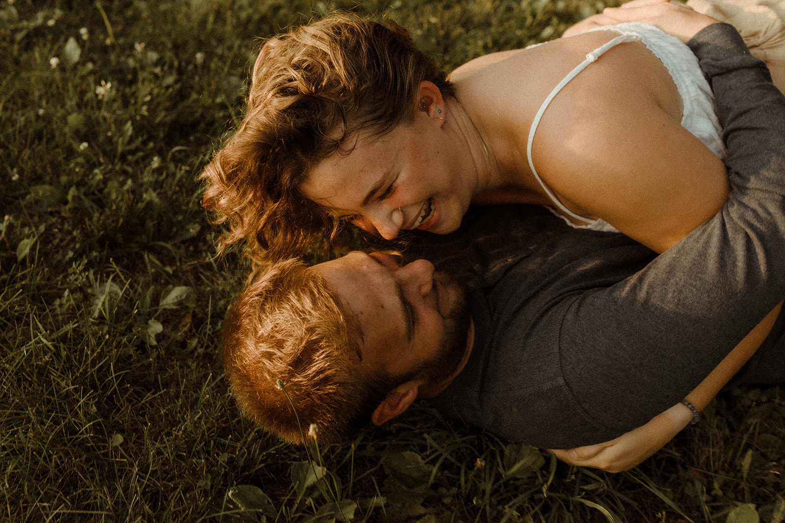 Romantic and intimate couples photoshoot in a field.