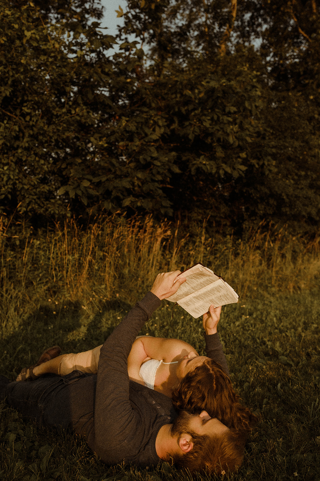 Sweet couple reading the bible together during their Upstate New York couples photoshoot.