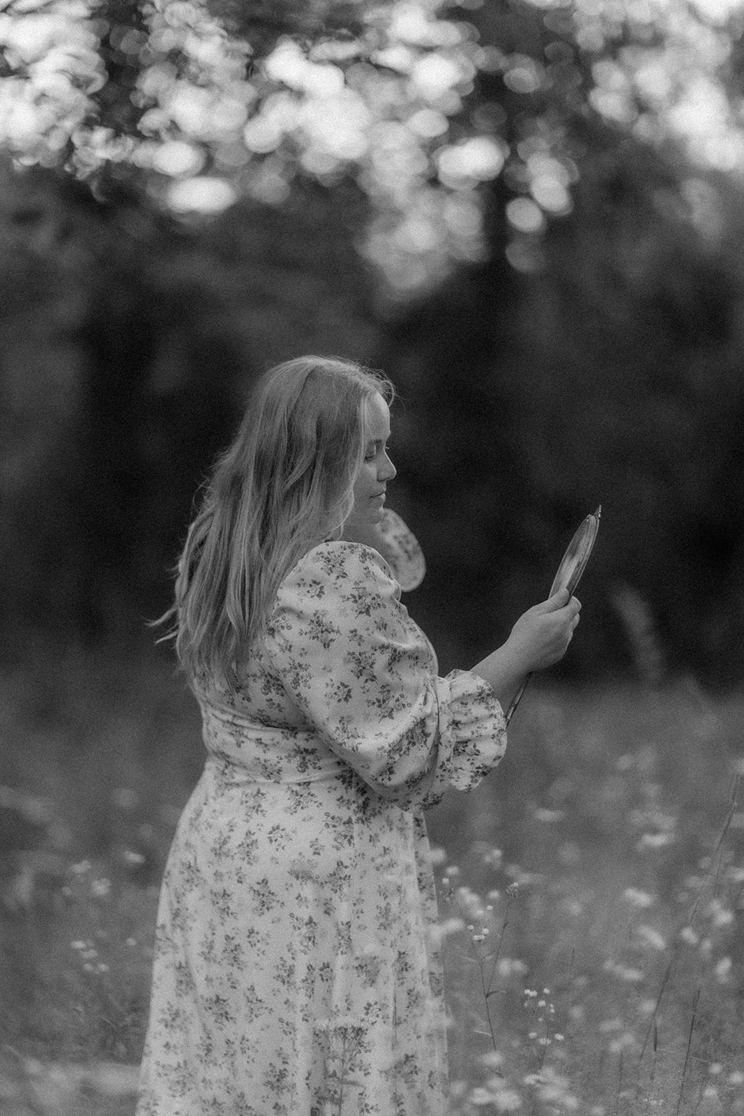stunning young lady poses in field for her black and white creative self portrait photos