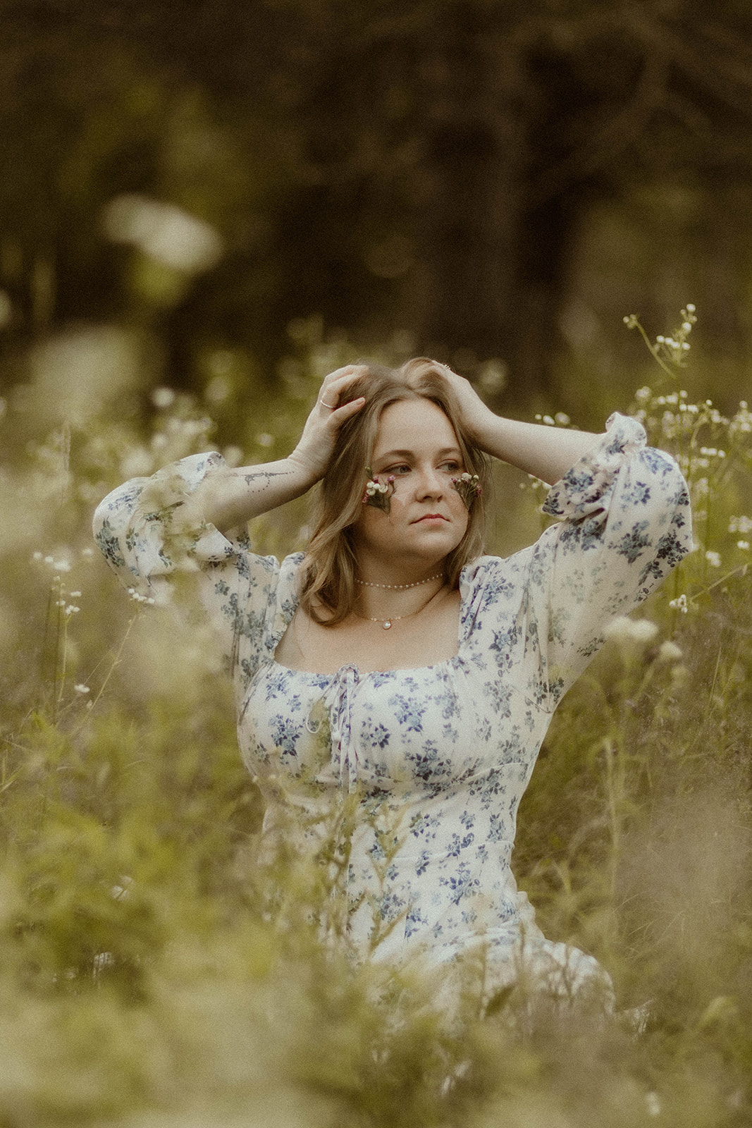 stunning young lady takes creative self portraits in a wildflower field