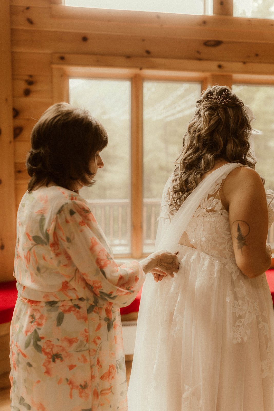 Beautiful bride shares a moment with her mom as she finalizes her preparations before her dreamy mountain elopement