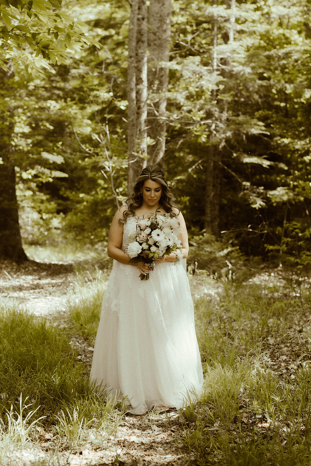 Stunning bride takes photo in the Adirondack mountain nature