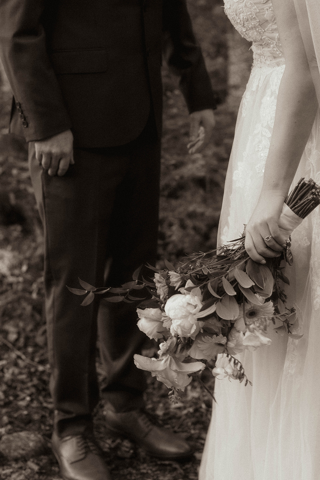 Photo of bride and groom with her bouquet before their mountain elopement