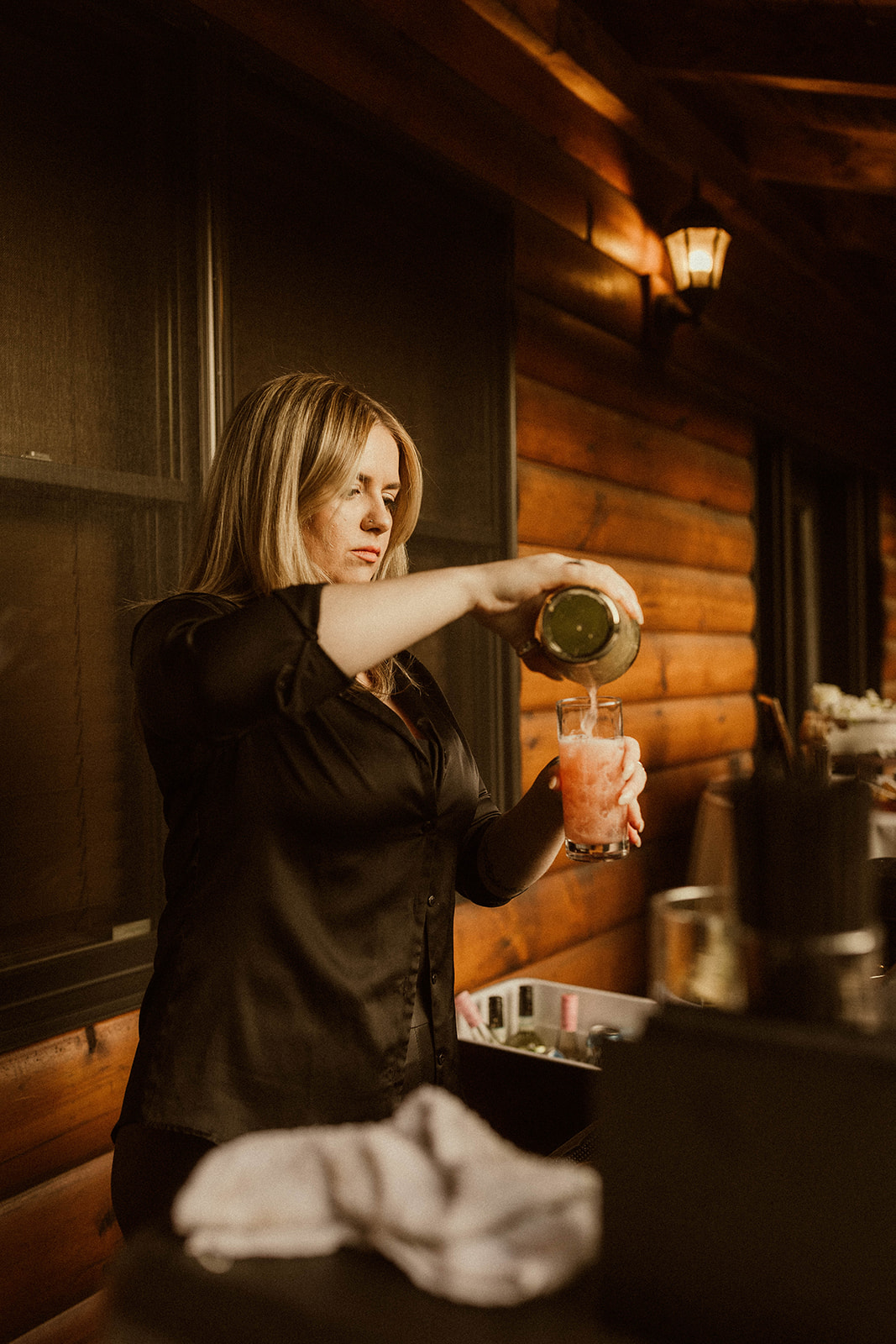 The bartender makes a cocktail at the dreamy EBS view lodge nestled in the Adirondack mountains