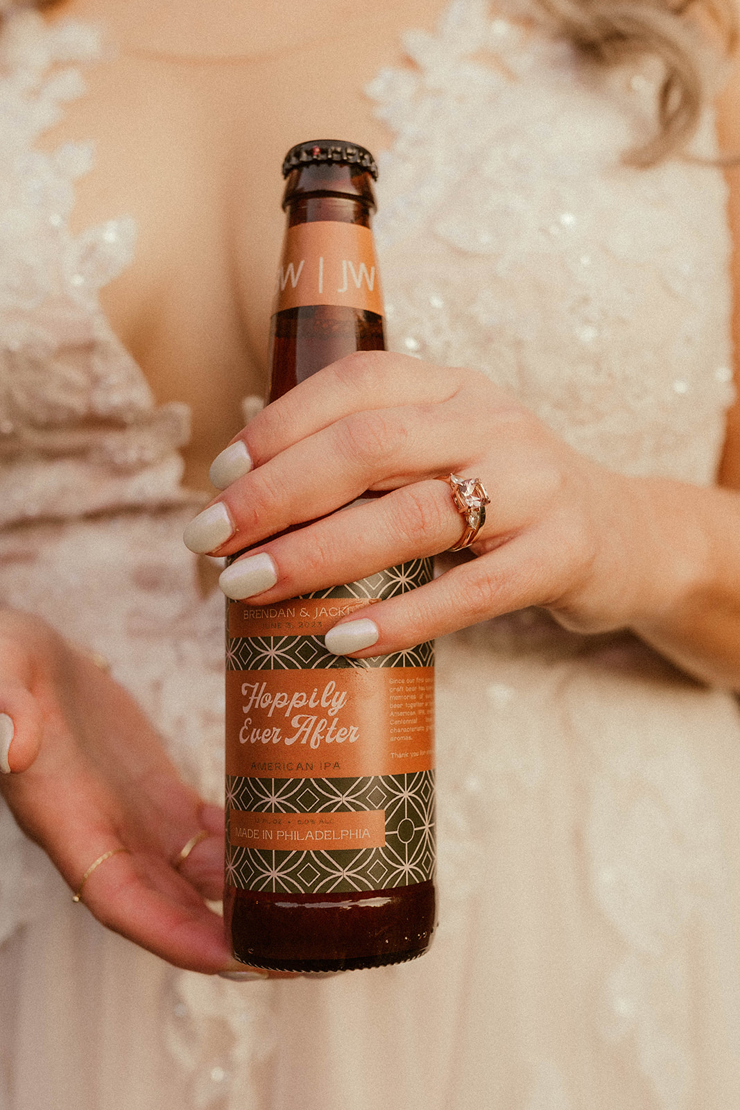 Stunning bride holds her favorite beer to show off her new ring!