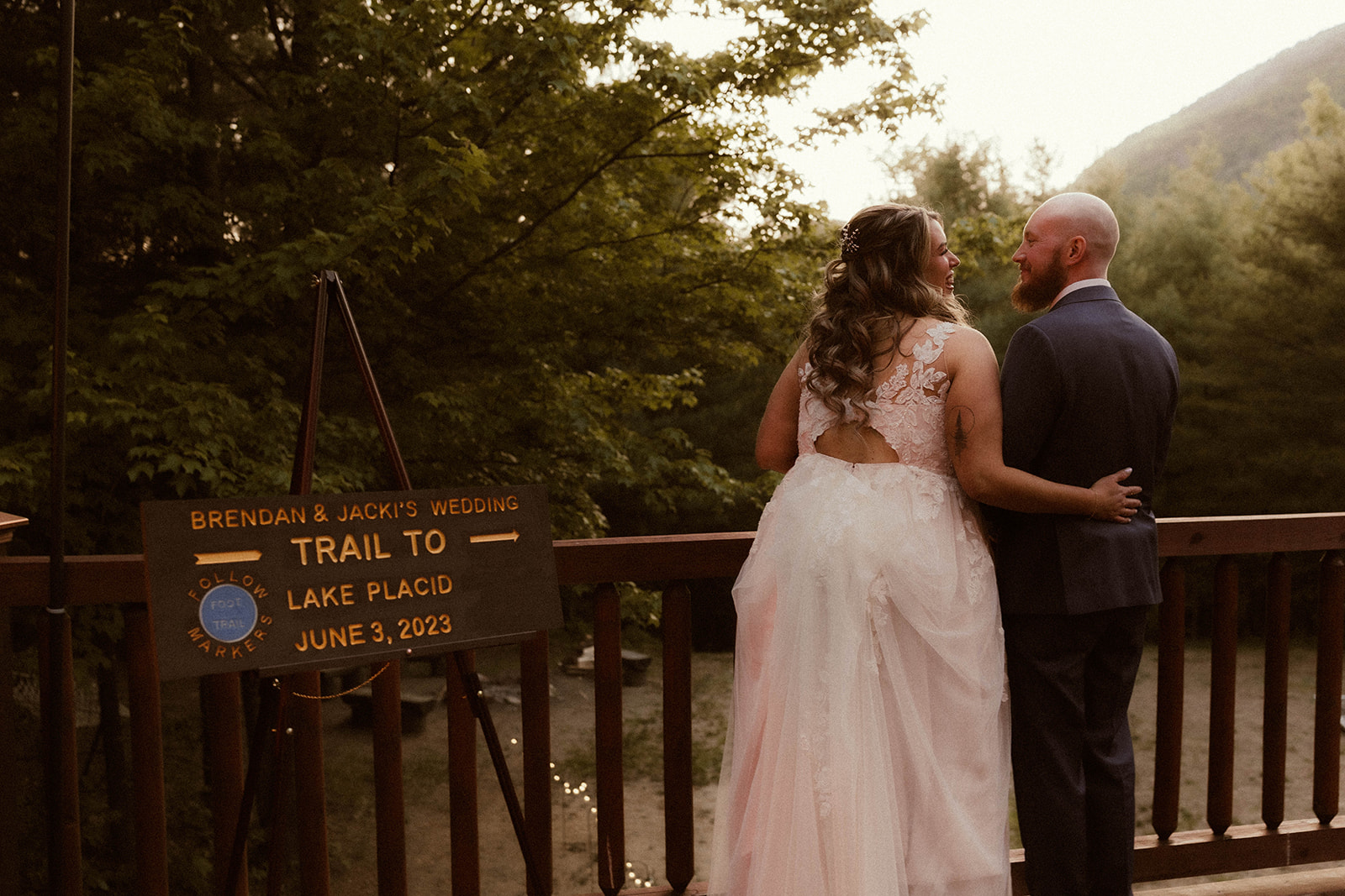 Beautiful bride and groom share a moment overlooking the majestic Adirondack mountain range