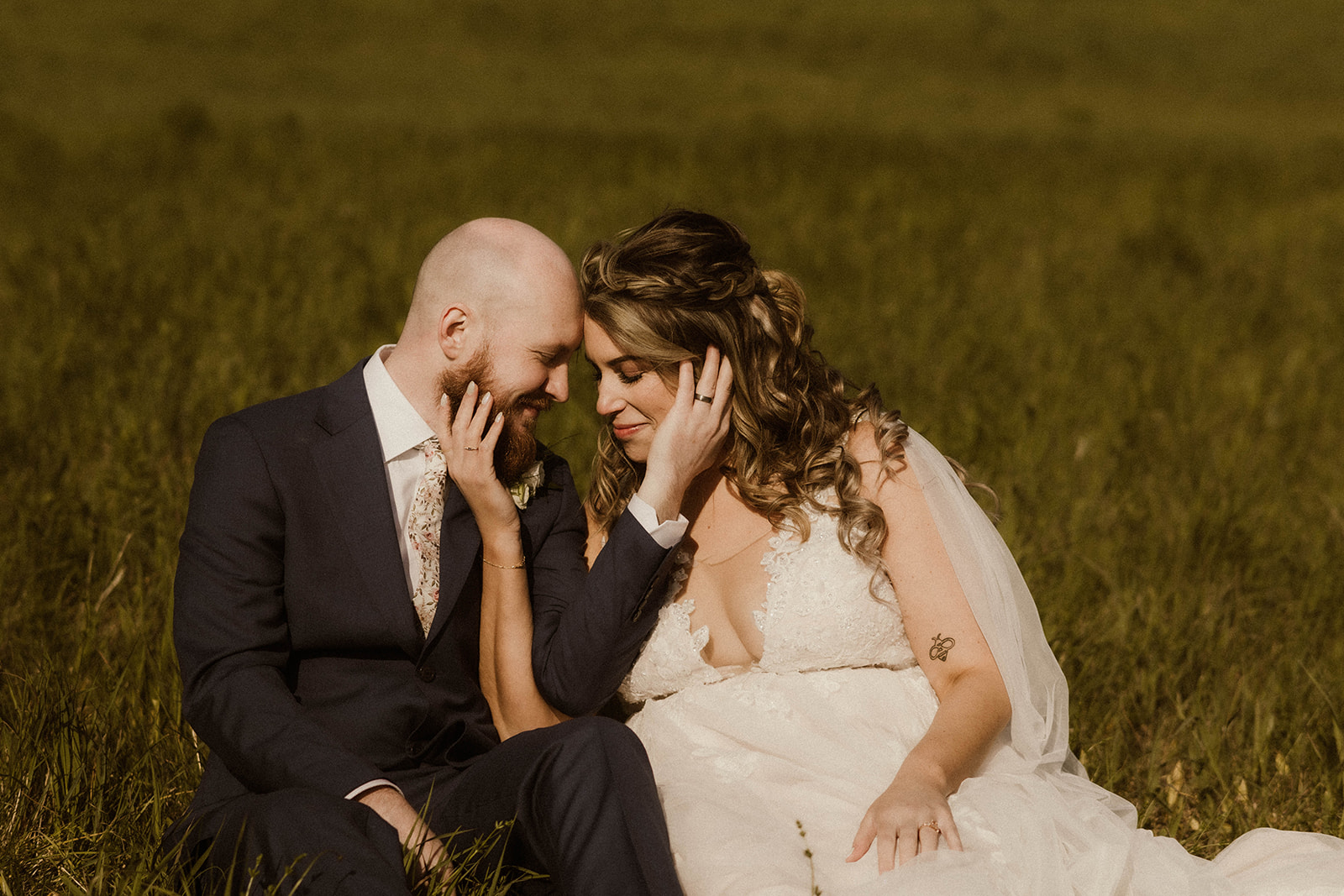 Stunning bride and groom sit together and share an intimate moment after their wedding