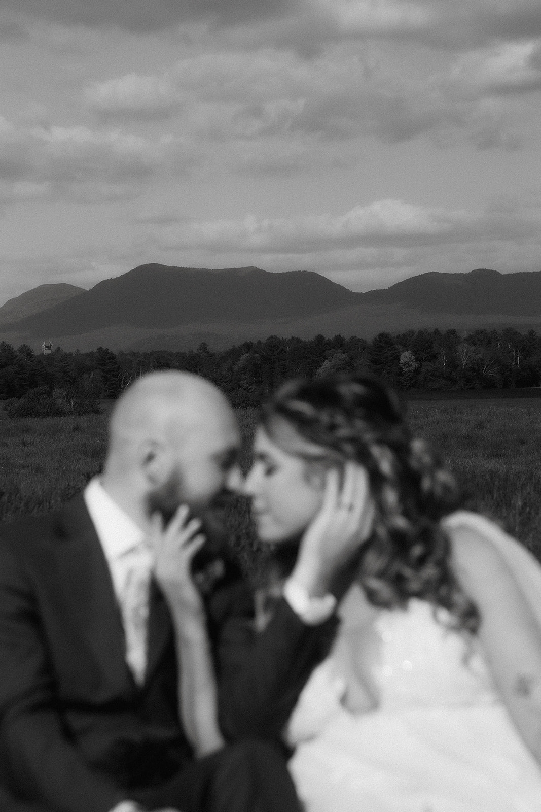 Beautiful bride and groom share an intimate moment in front of the beautiful backdrop of the Adirondack mountain