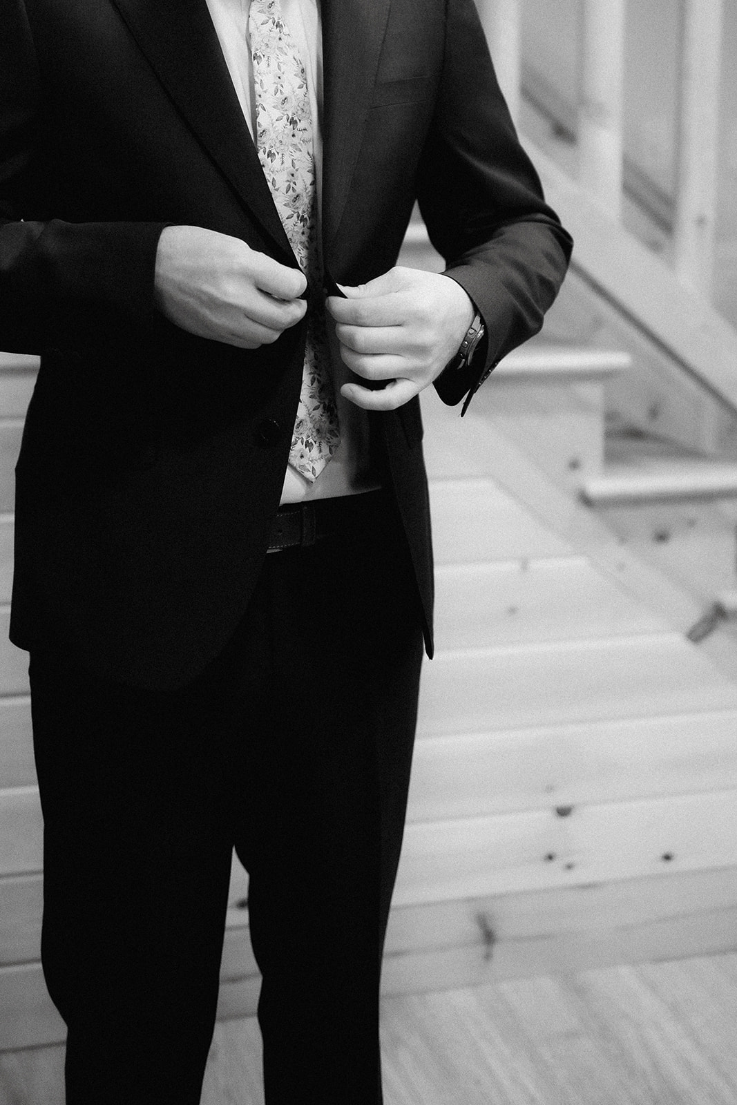 A simple candid shot of a groom finishing getting ready for his romantic and adventurous Adirondack mountain elopement