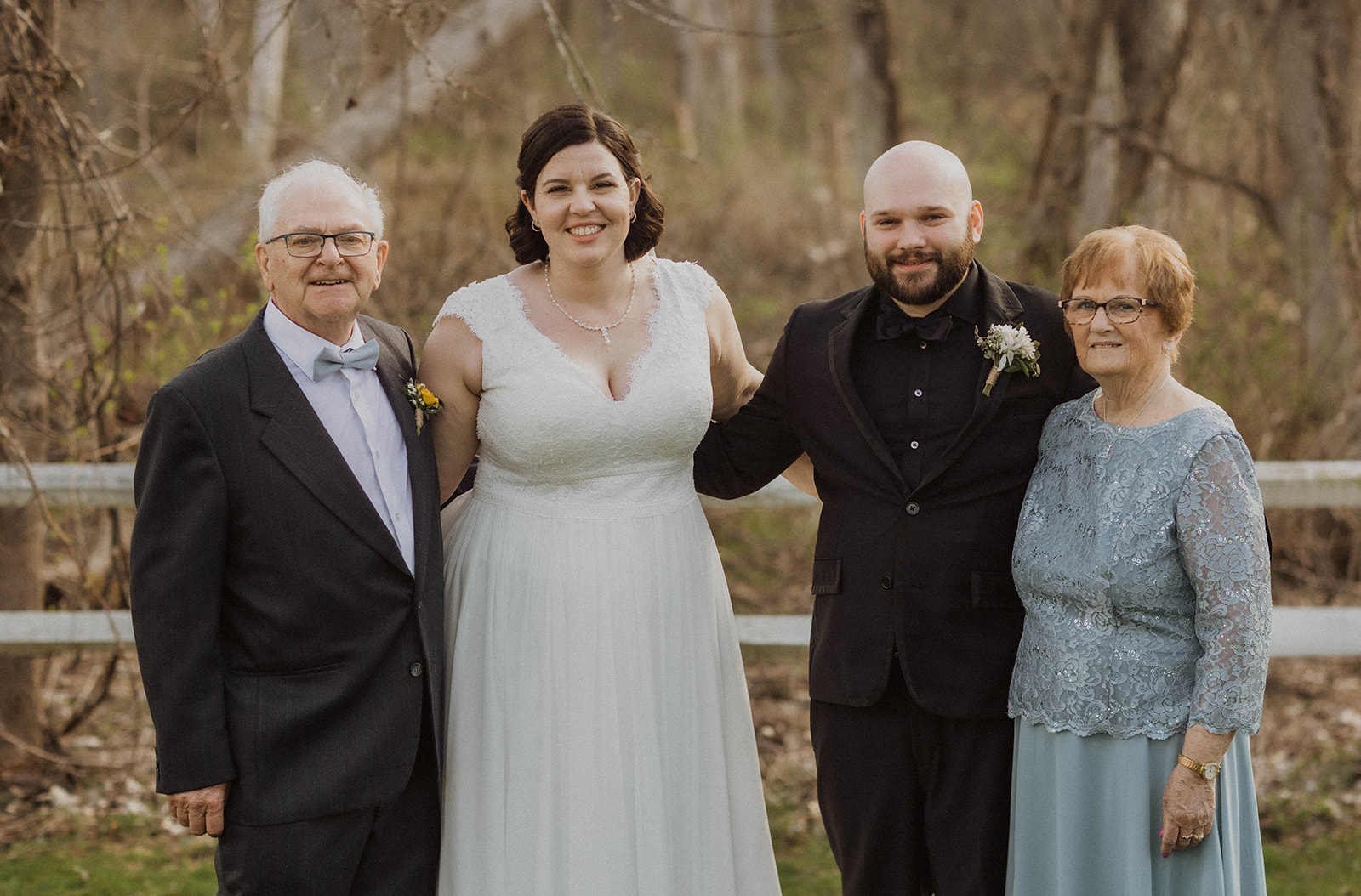 Bride and groom pose with their family outside their dreamy Upstate New York wedding venue