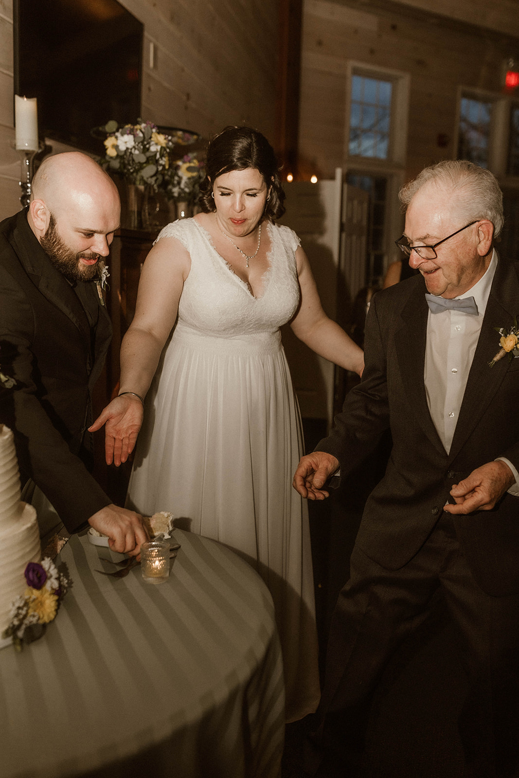 Wedding guest helps bride with her piece of cake during her dreamy wedding day