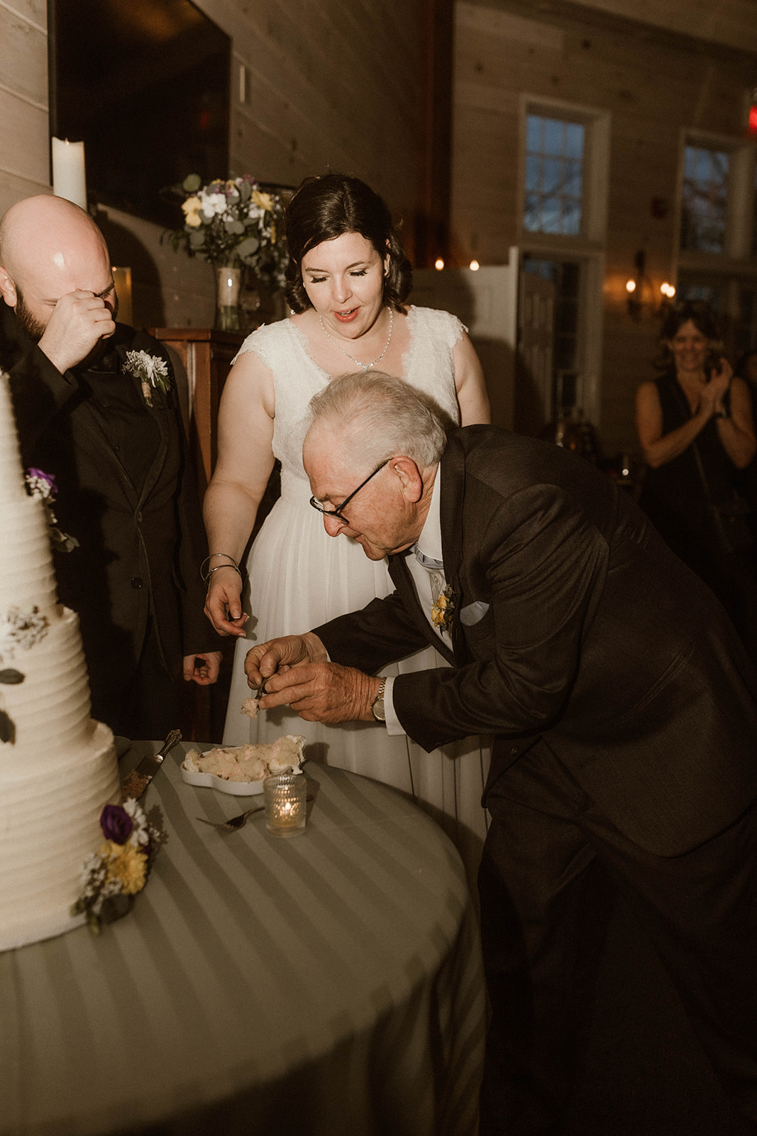Wedding guest helps bride with her piece of cake during her dreamy wedding day