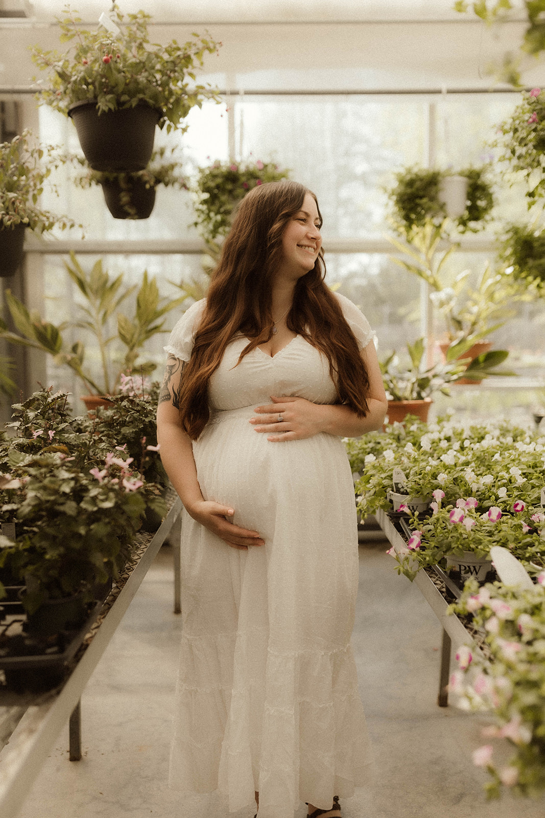 Stunning soon to be mother poses with flowers during her unique maternity shoot