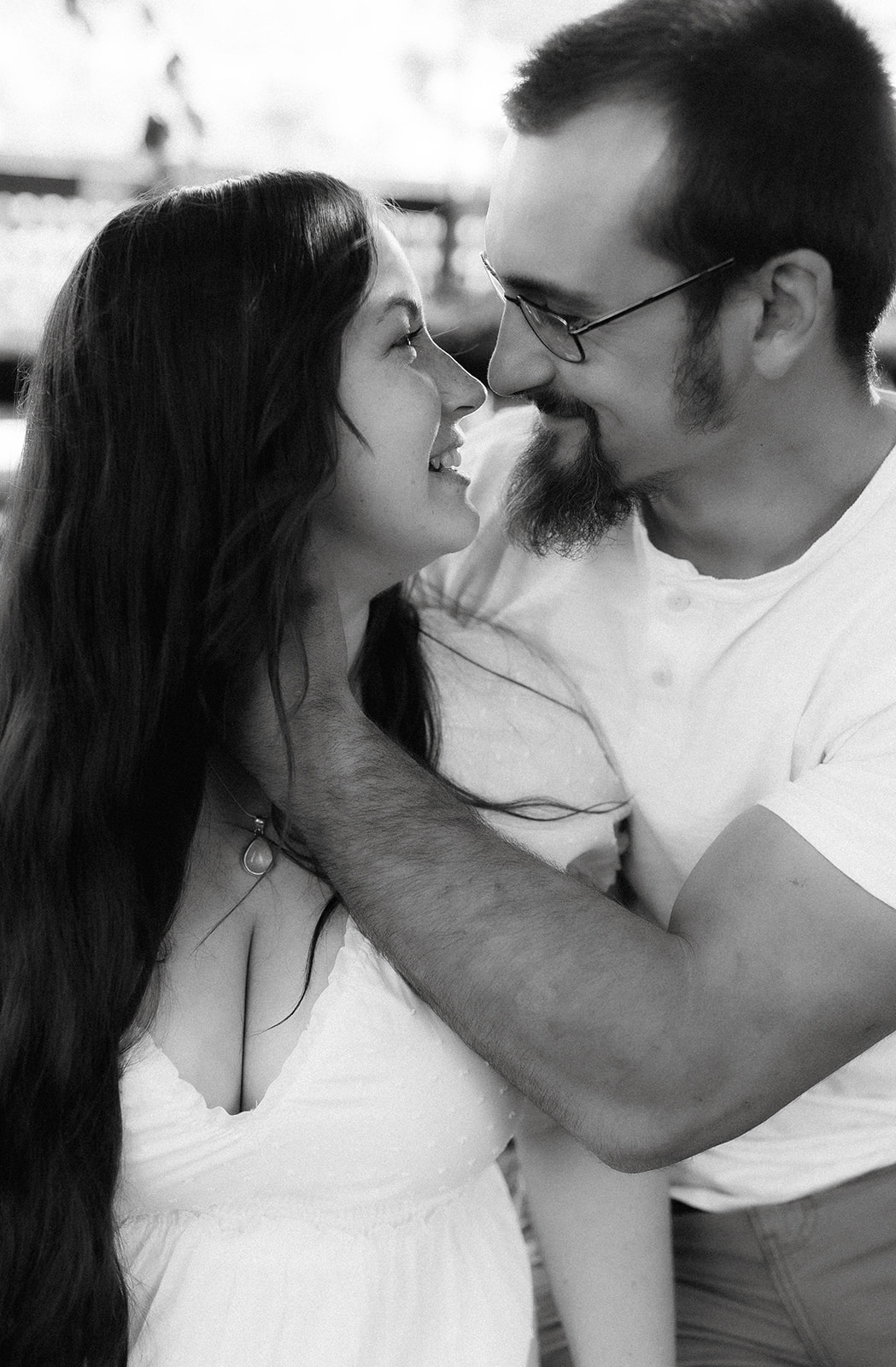 Timeless black and white soon to be mom and dad share a romantic pose during their nursery maternity photoshoot