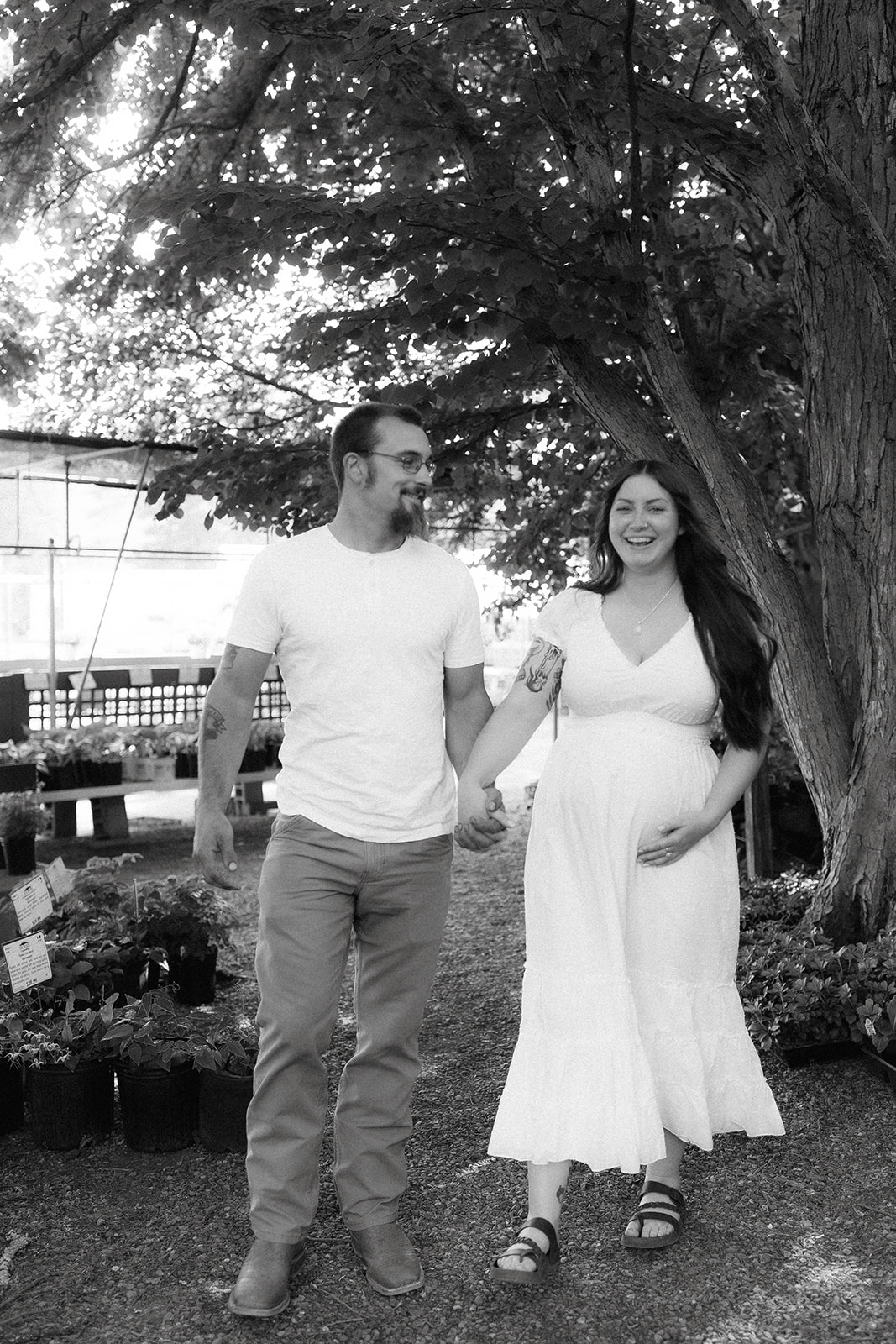 Timeless black and white soon to be mom and dad pose during their nursery maternity photoshoot