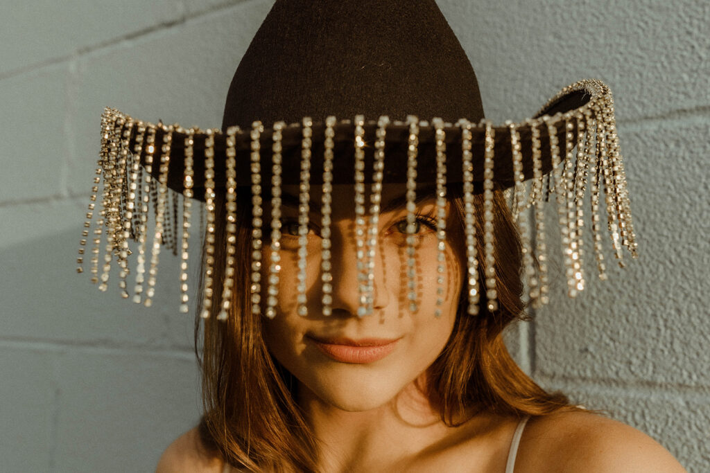 photo of stylish woman with a cowgirl hat on. 