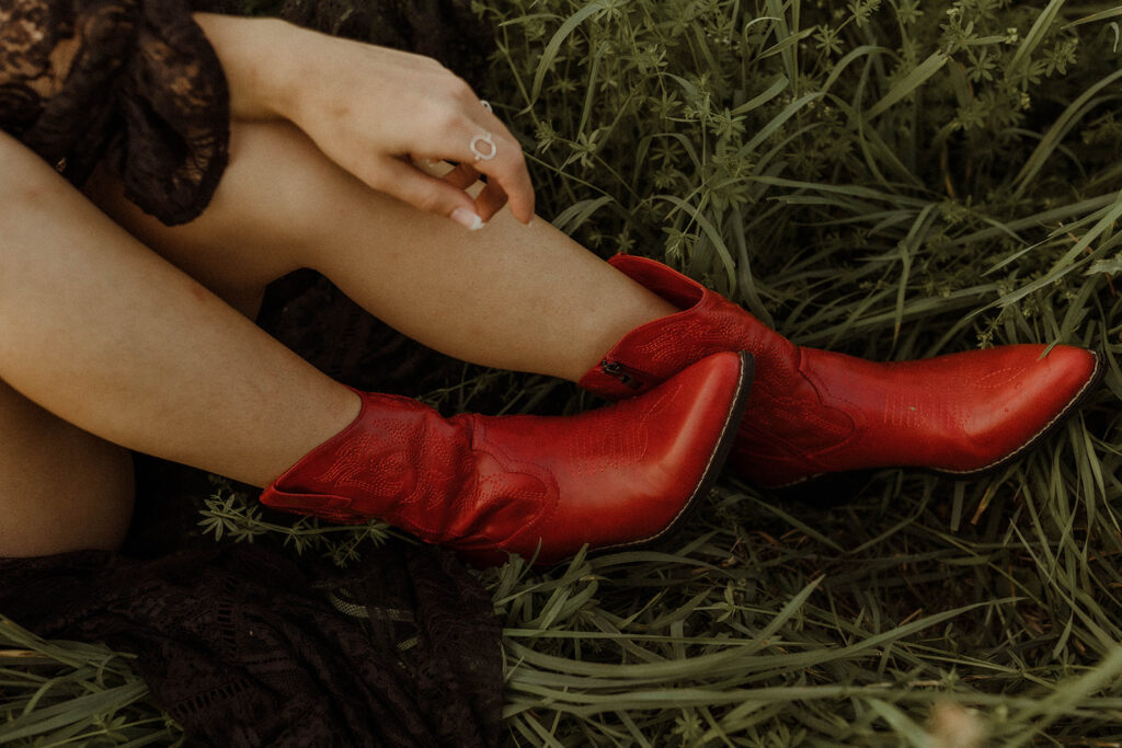 detail photo of western cowgirl wearing red cowgirl boots.