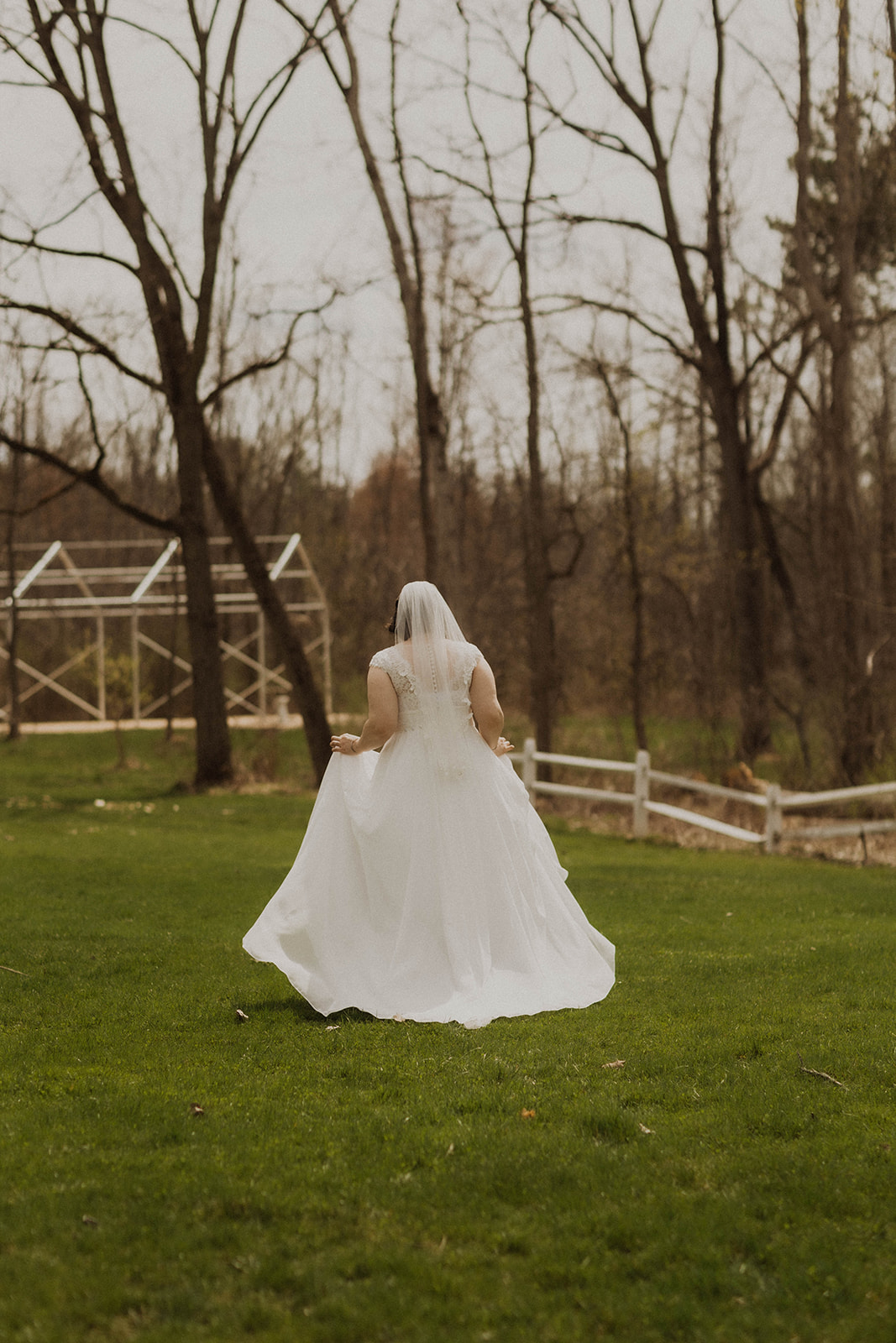 Bride walks through the empty upstate New York trees