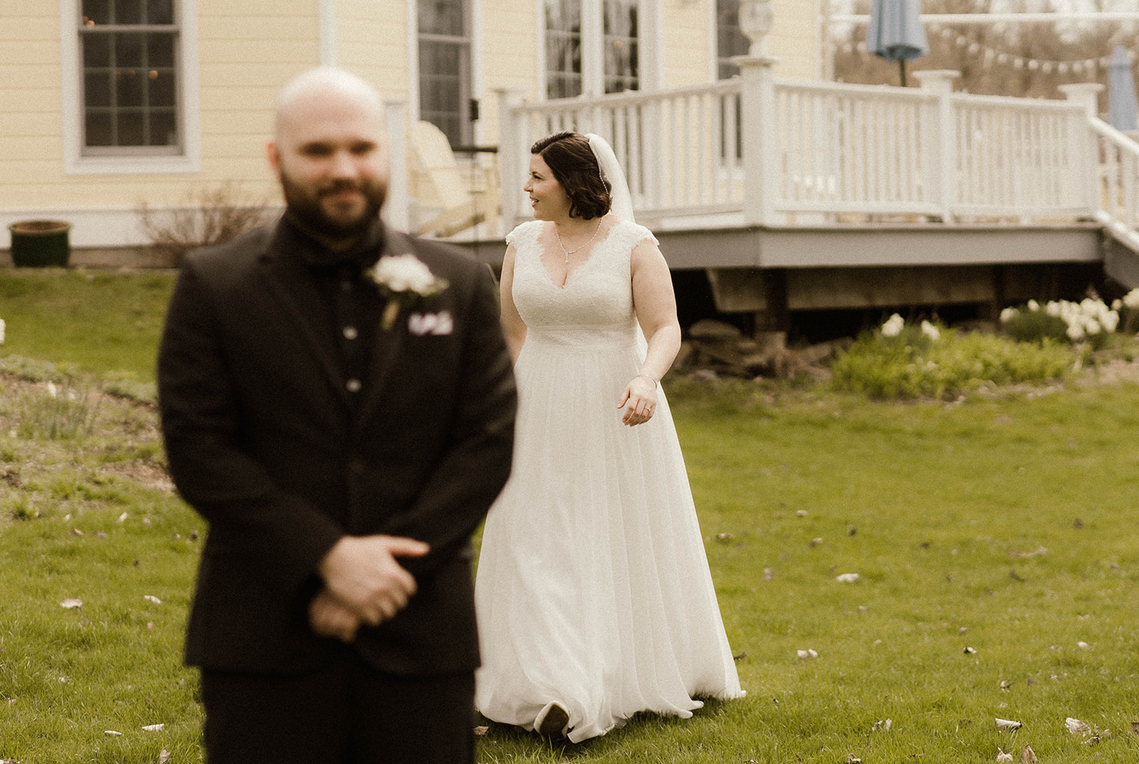 Bride approaches her handsome groom for first look photos