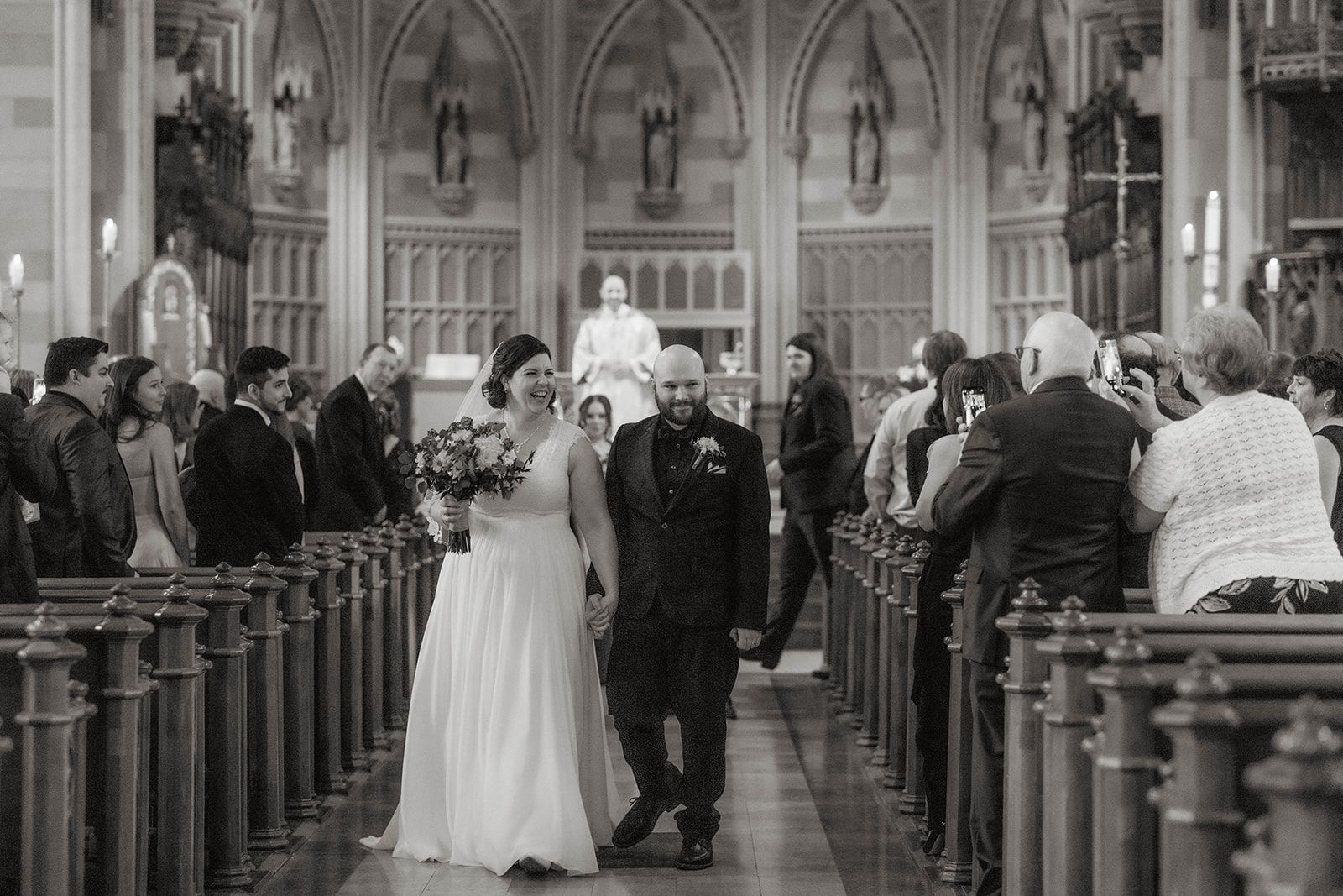 Stunning bride and groom walk down the aisle of their upstate New York wedding