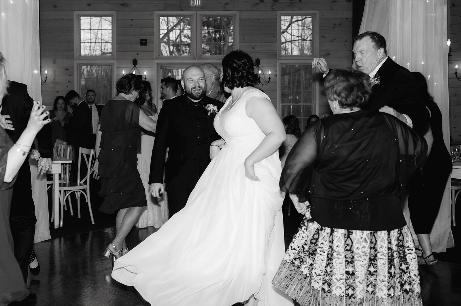 Bride and groom dance surrounded by their wedding guests