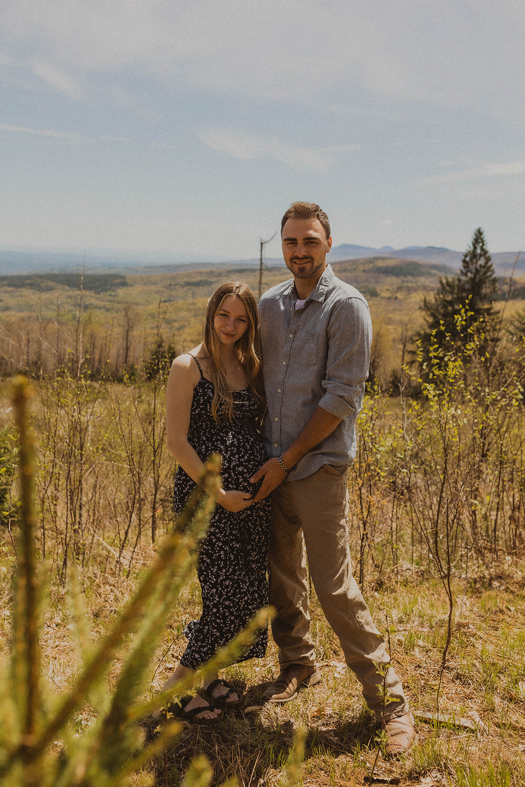 Future parents pose intimately together during their mountainside maternity photos 