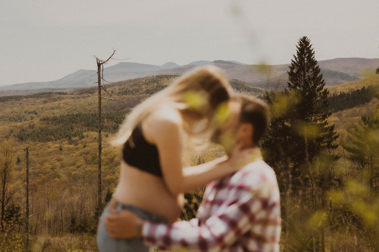 Future parents pose intimately together during their nature maternity photos