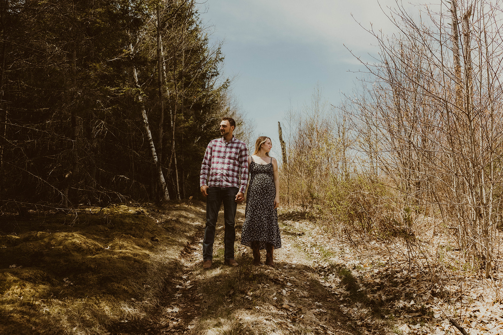 Future parents pose candidly together during their western maternity photos