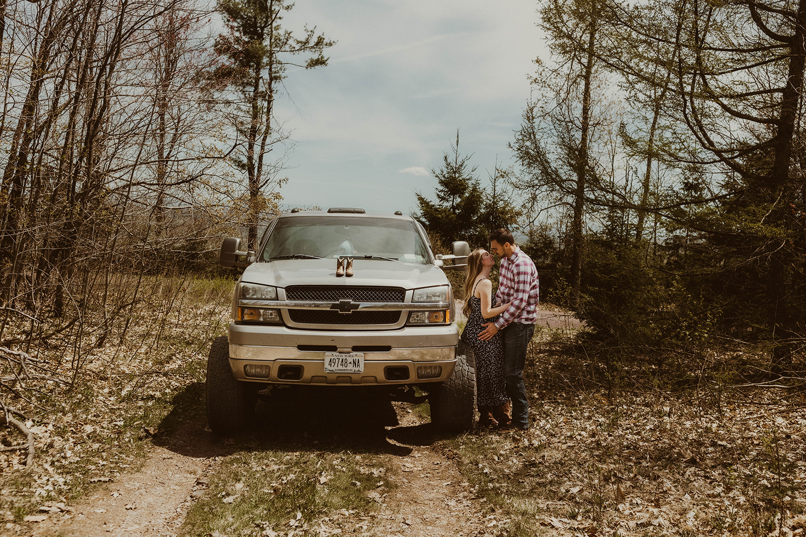 Future parents pose intimately with their truck together during their western maternity photos