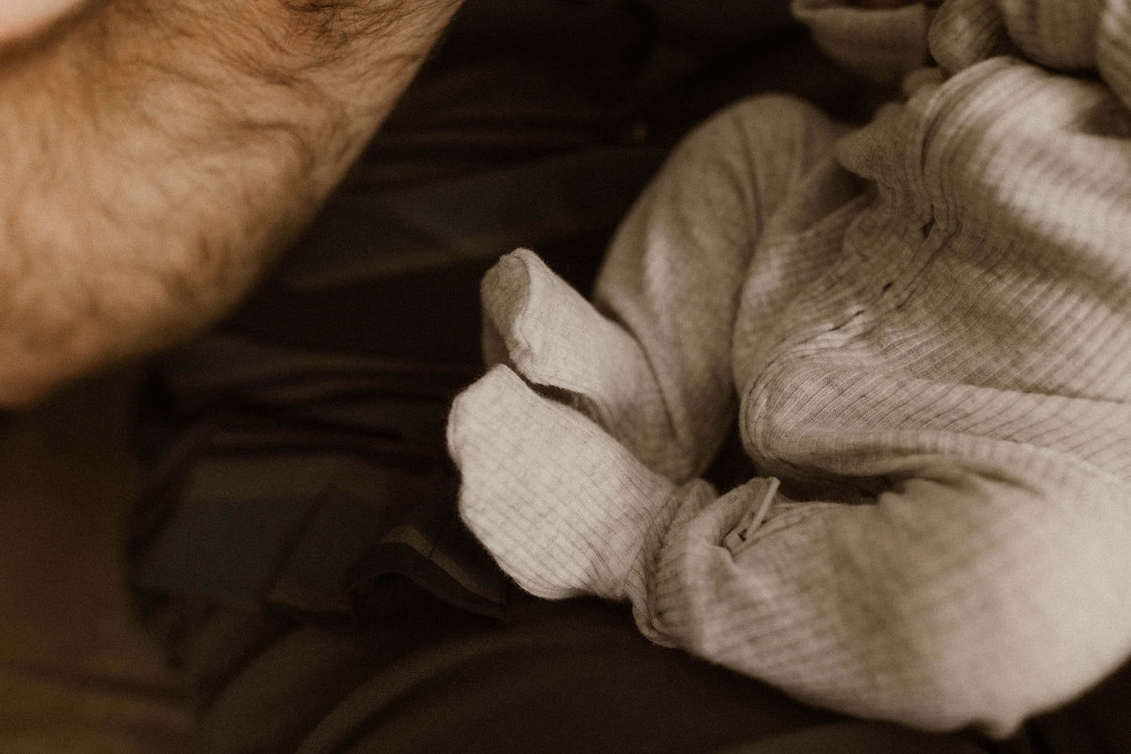 Detail shot of the little mans legs in his PJ's during his in home newborn photoshoot