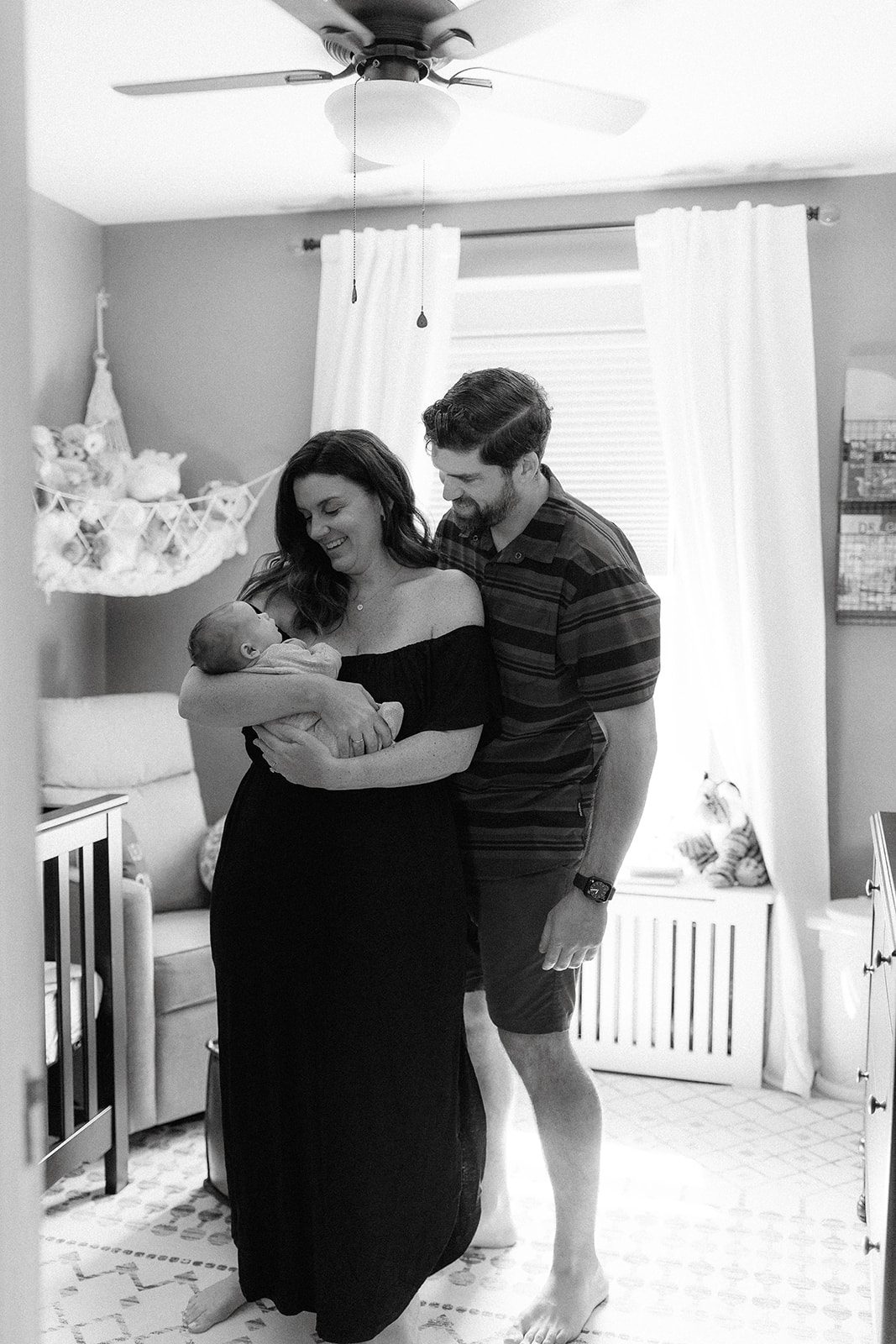 A beautiful new family pose together during their in home newborn photography session