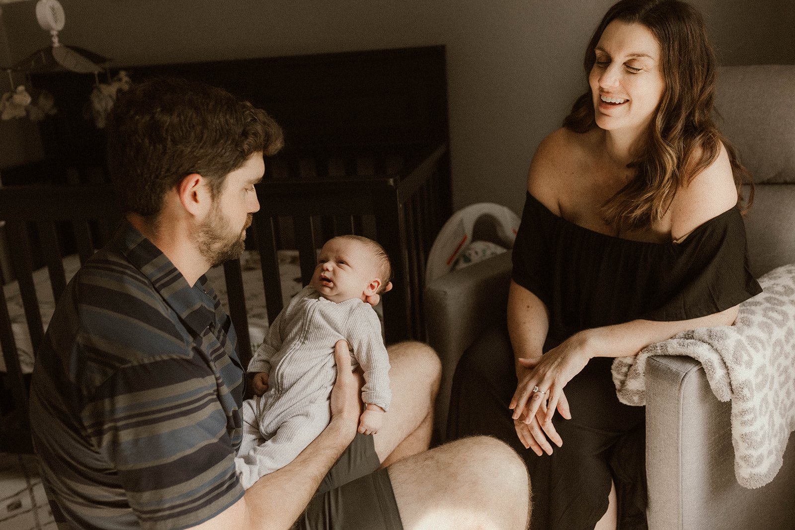 A beautiful new family pose together during their in home newborn photography session