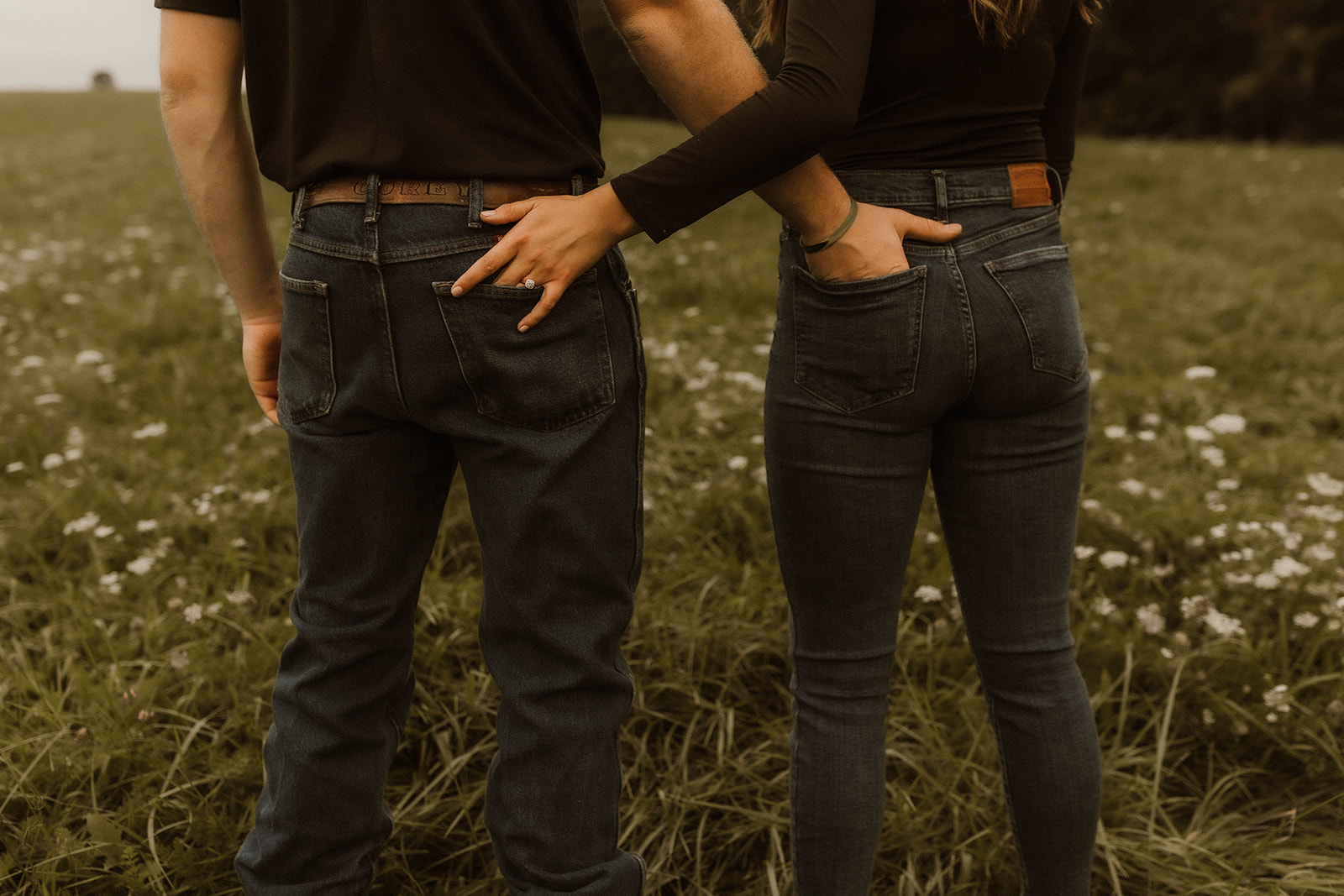 Couple pose with their hands in each others back jean pockets during their dreamy upstate NY fall engagement photos