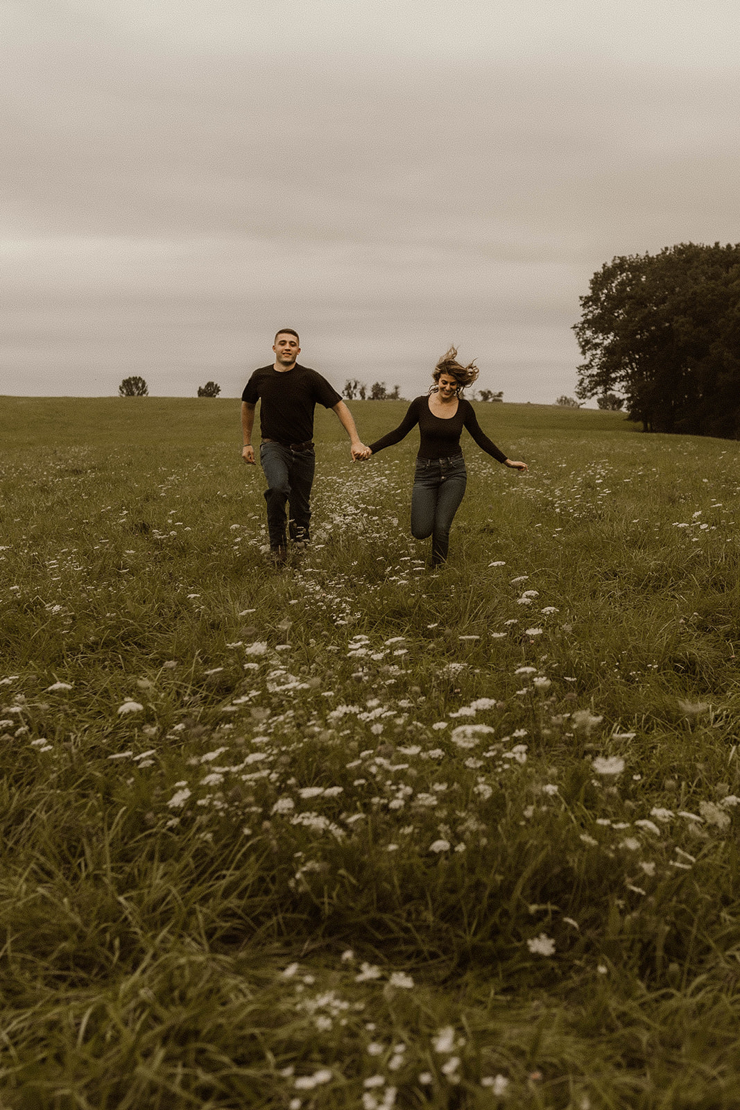 Beautiful couple share a laugh and run together during their Upstate NY Engagement Photos