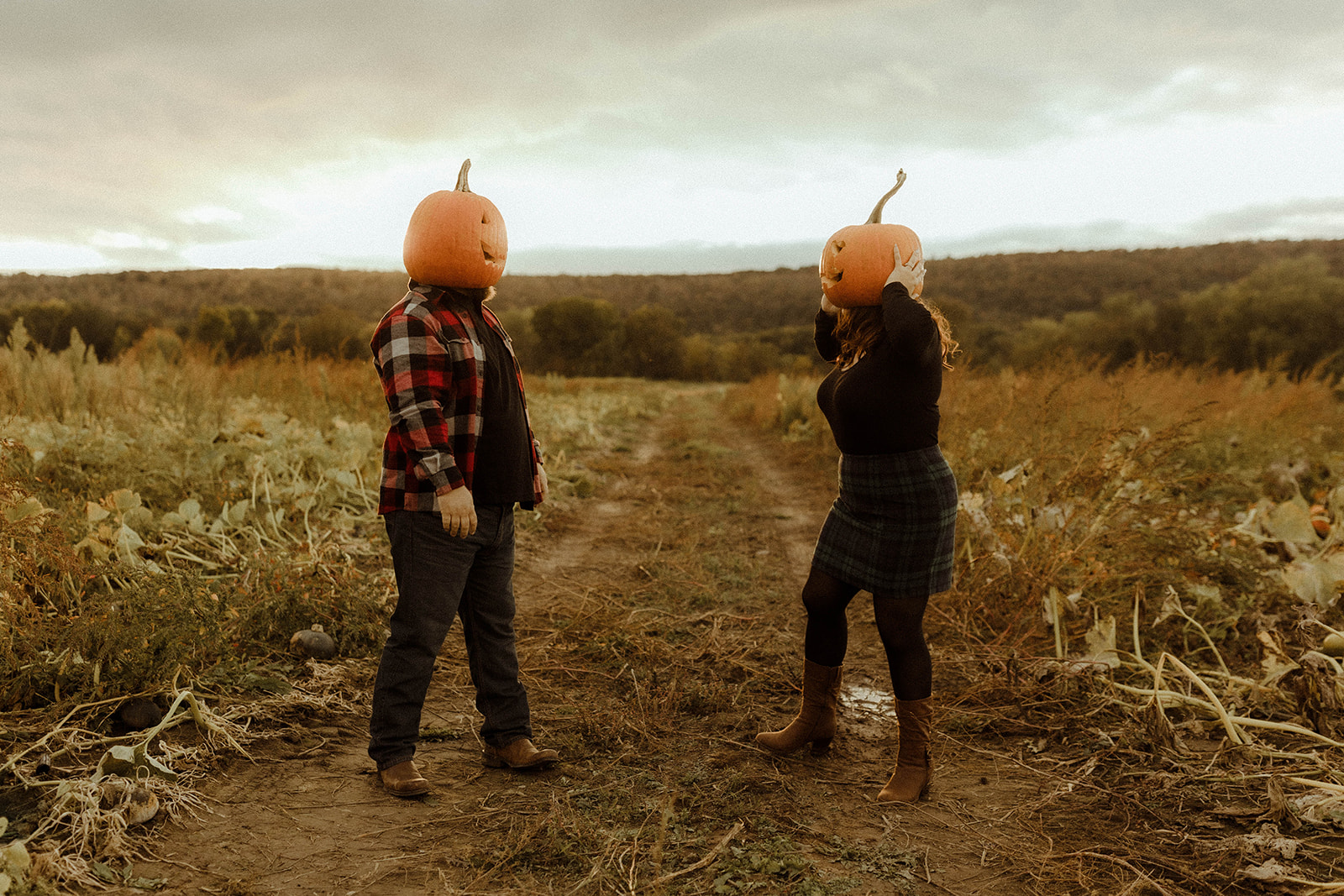 Beautiful couple pose in a pumpkin patch 