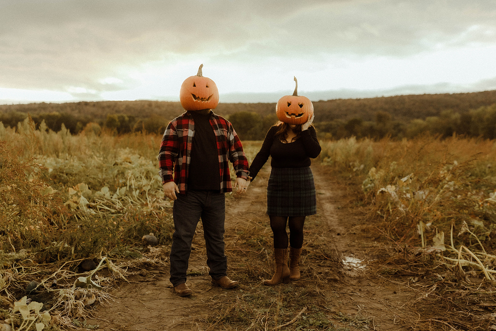 Beautiful couple pose in a pumpkin patch during their upstate New York engagement photos