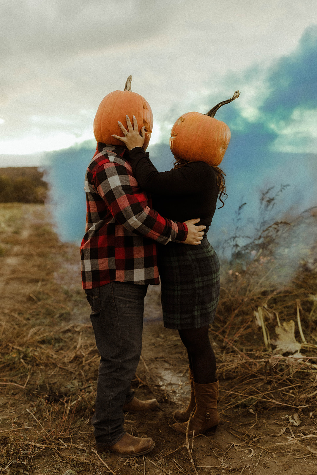 Gorgeous couple pose in a pumpkin patch during their upstate New York engagement photos