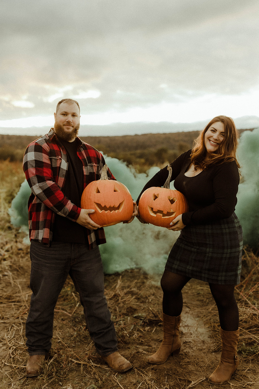 Beautiful couple pose in a pumpkin patch
