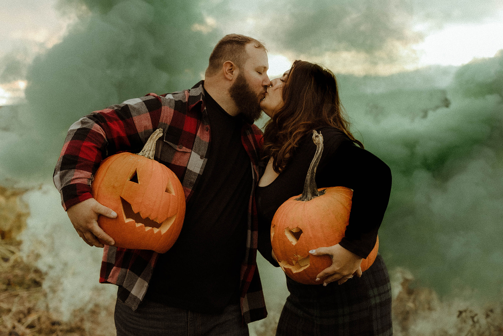 Beautiful couple pose in a pumpkin patch during their upstate New York engagement photos