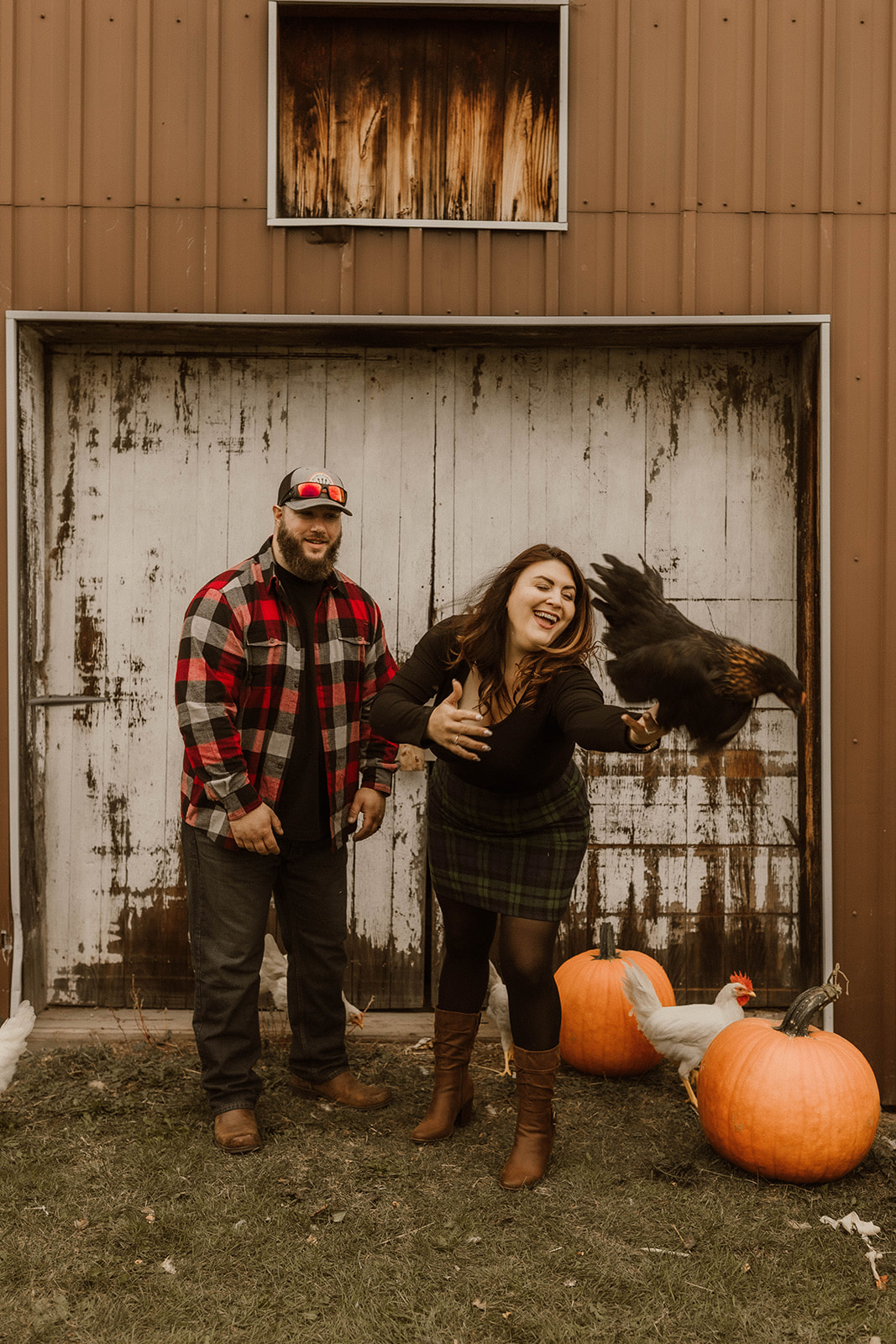 Stunning couple pose together on their farm during their Upstate New York farm engagement photos