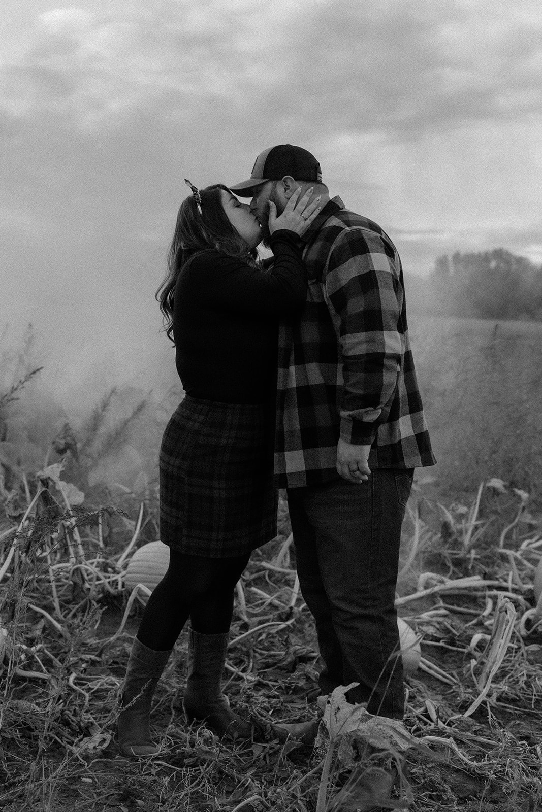 Beautiful couple pose together on their farm during their Upstate New York farm engagement photos