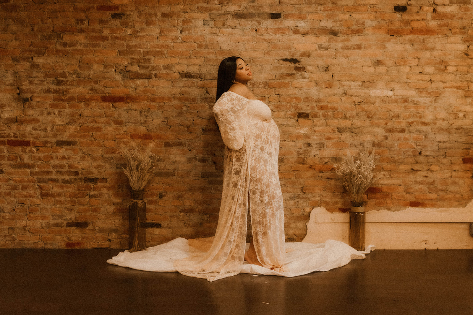 Standing maternity session pose with flowing dress