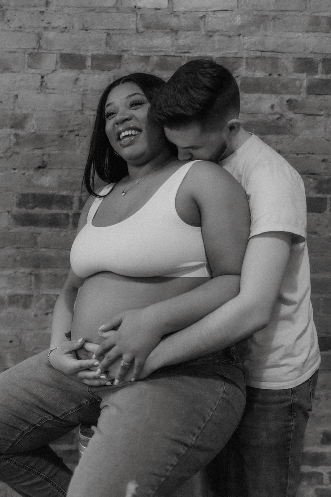 Maternity session with couple sitting and standing